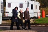 Resident Nancy Stewart shows committee members Mary Fee MSP and John Mason MSP around the site
